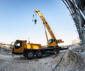 Tower crane lifting materials on an active construction job-site.